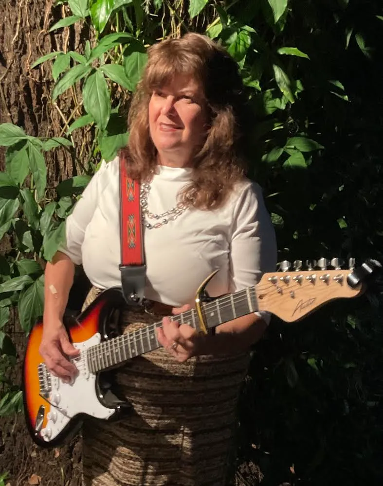 Kathy Lou Waskett with her guitar