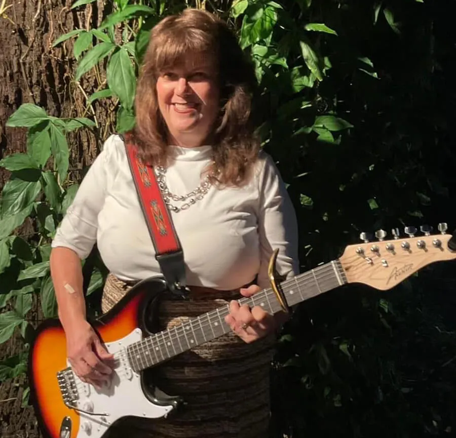 Kathy Lou Waskett with her guitar